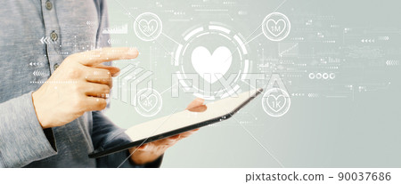 Get more likes concept with young man holding a tablet Get more likes concept with young man holding a tablet 90037686