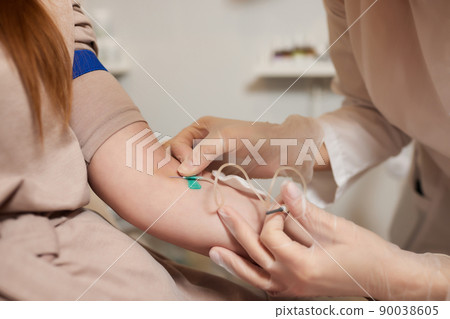 Young woman in blood transfusion concept hand. Young woman in blood transfusion concept hand. 90038605