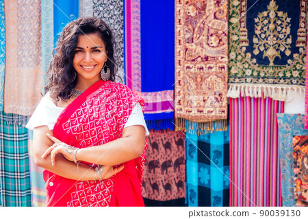 business lady in red traditional sari and jewelery clothes shop owner cashmere yak wool shawls Delhi market.female seller in goa india arambol sale shop.designer seamstress tailor girl in Arambol Goa 90039130
