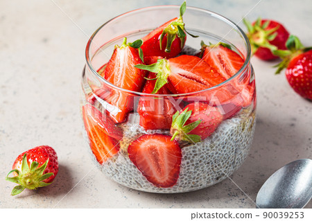 Homemade chia pudding with strawberry in jar, gray background. Homemade chia pudding with strawberry in jar, gray background. 90039253