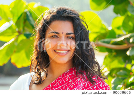 portrait of attractive indian female model in vacation on paradise tropical beach by ocean sea. hindu woman with kundan jewelry set traditional India costume red wedding sari.asian girl sensual look 90039606
