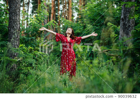 Connecting with nature benefits mental health. Nature Therapy Ecotherapy Helps Mental Health. Nature Impact Wellbeing. Woman in red dress enjoying nature 90039632