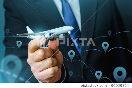 Passenger plane in businessmans hand. Commercial flight management and set new directions. Low cost travel flights. Air traffic communication. Delivery Services. Business trips and tourism. Air miles 90039864