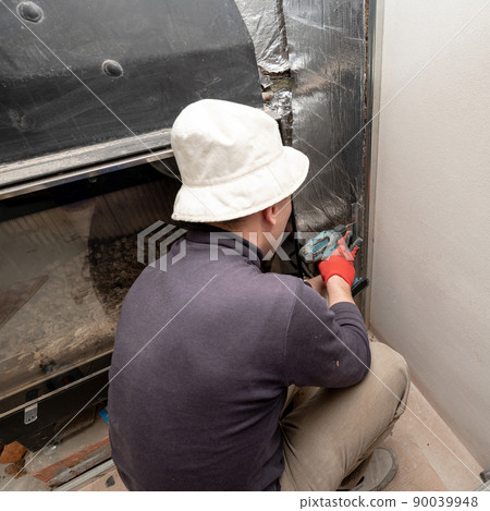 Installation of mineral wool with foil around the fireplace for thermal protection and high temperatures for the walls. Installation of mineral wool with foil around the fireplace for thermal protection and high temperatures for the walls. 90039948