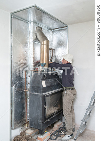 Installation of mineral wool with foil around the fireplace for thermal protection and high temperatures for the walls. Installation of mineral wool with foil around the fireplace for thermal protection and high temperatures for the walls. 90039950