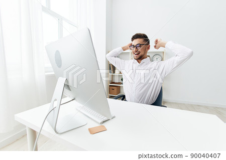 handsome businessman wearing glasses sits at a desk office worked office handsome businessman wearing glasses sits at a desk office worked office 90040407