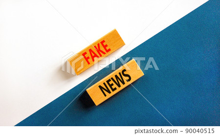 Fake news symbol. Wooden blocks with concept words Fake news on beautiful white and blue background. Business media and fake news concept. Copy space. 90040515
