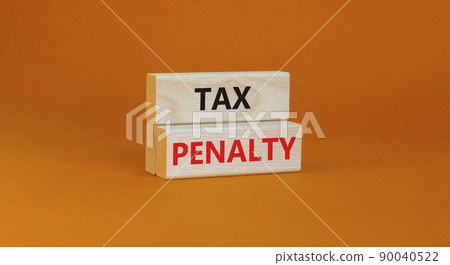 Time to tax penalty symbol. Concept words Tax penalty on wooden blocks on a beautiful orange background. Business and tax penalty concept. Copy space. 90040522