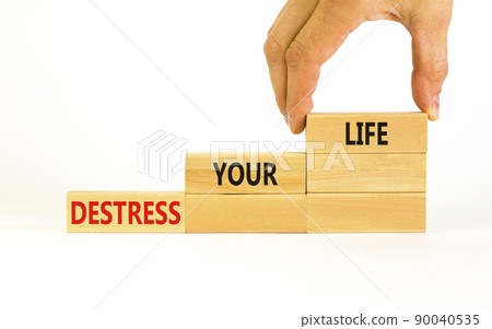Destress your life symbol. Concept words Destress your life on wooden blocks. Doctor hand. Beautiful white table white background. Psychological business and destress your life concept. Copy space. 90040535