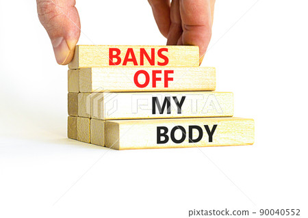Bans off my body symbol. Concept words Bans off my body on wooden blocks on a beautiful white table white background. Women rights concept. Business social issues and bans off my body concept. 90040552