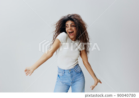 GOOD OFFER. Shocked excited happy pretty Latin female with waving afro hair, spreading hands, say Yeah, looking aside, stay isolated over white background. Copy space, free place, fashion banner 90040780