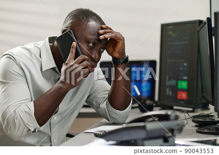 Young Black man working with in stock trading industry feeling stressed out talking to dissatisfied client 90043553