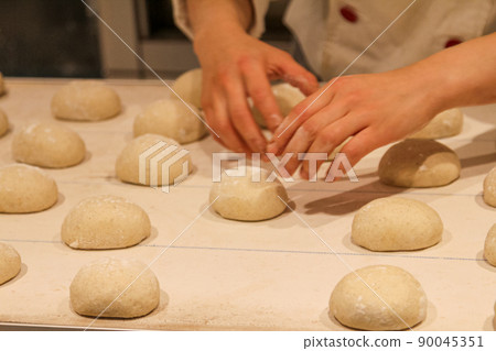 Bread making work by a baker Bread making work by a baker 90045351