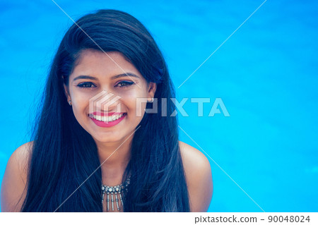 beautiful indian woman toothy white smile selfie portrait on smartphone camera summer cafe by sea by the swimming pool goa beautiful indian woman toothy white smile selfie portrait on smartphone camera summer cafe by sea by the swimming pool goa 90048024
