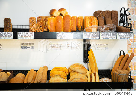 Baked baguettes on showcase in bakery shop Baked baguettes on showcase in bakery shop 90048443