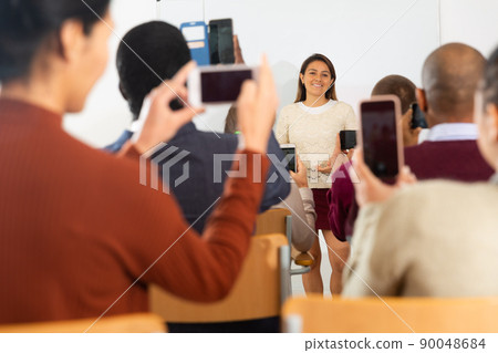 Lecturer talking to students during seminar Lecturer talking to students during seminar 90048684