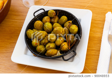 Pickled olives with a stone - a typical Spanish tapas. 90048933