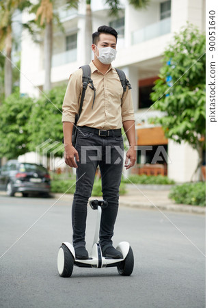 Man Riding on Personal Transporter Man Riding on Personal Transporter 90051640