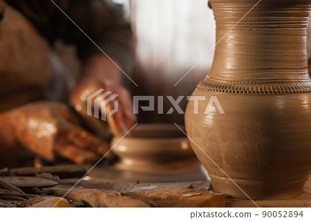 Potter working a piece of clay Potter working a piece of clay 90052894