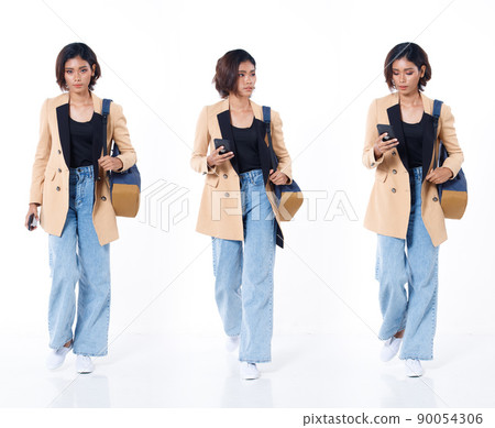 Full length of Asian Indian 20s working woman with curl hair hold cell smart phone backpack blazzer 90054306
