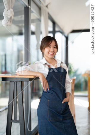 Portrait of woman barista startup successful small Asian business owner in coffee shop.Asian woman barista cafe owner. SME entrepreneur seller business concept 90055427