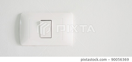 Electronic lighting switch with white wall background. home electrical power. 90056369