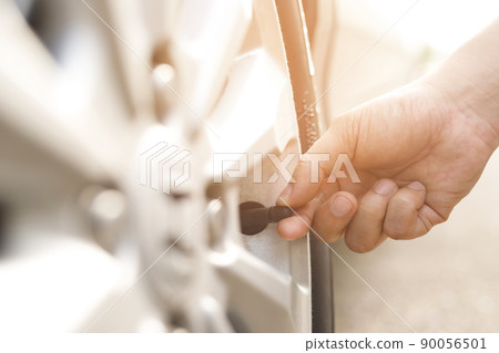 close up hand man car parking a check and inflate the tire fill up the air for safe driving on the go. Transportation travel vehicle concept. close up hand man car parking a check and inflate the tire fill up the air for safe driving on the go. Transportation travel vehicle concept. 90056501