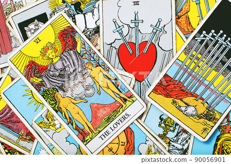 A pile deck of Tarot cards gypsy inspired on a wooden background scattered and haphazardly arranged. Fortune teller, Magician, wizard. Horoscope.. A pile deck of Tarot cards gypsy inspired on a wooden background scattered and haphazardly arranged. Fortune teller, Magician, wizard. Horoscope.. 90056901