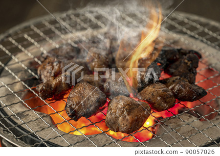 Charcoal grilling of chicken 90057026