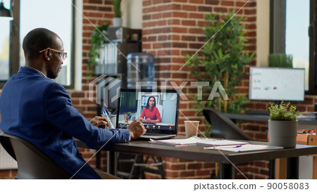 African american worker meeting with businesswoman on online video call, using teleconference chat to have remote conversation. Talking on virtual internet webcam videoconference. African american worker meeting with businesswoman on online video call, using teleconference chat to have remote conversation. Talking on virtual internet webcam videoconference. 90058083