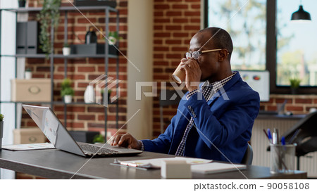 Company specialist analyzing online statistics on website, using internet report to write email on laptop. Office worker planning startup project presentation with paperwork app. Tripod shot. Company specialist analyzing online statistics on website, using internet report to write email on laptop. Office worker planning startup project presentation with paperwork app. Tripod shot. 90058108