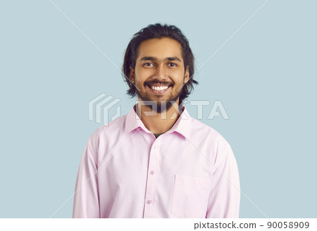 Portrait of happy Indian man with beautiful snow-white smile on pastel light blue background. Portrait of happy Indian man with beautiful snow-white smile on pastel light blue background. 90058909