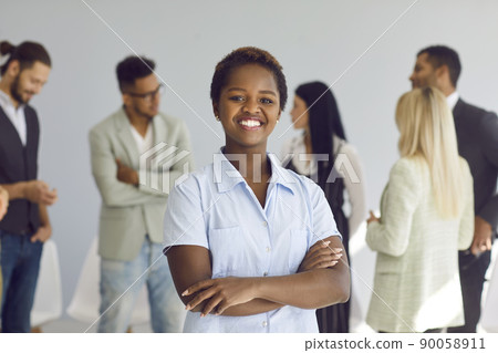 Portrait of happy black businesswoman and team leader standing in office and smiling Portrait of happy black businesswoman and team leader standing in office and smiling 90058911