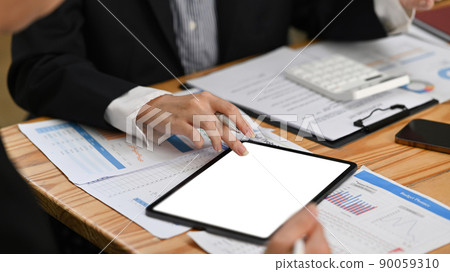 Cropped shot female financial advisor explaining some information in digital tablet to her client 90059310