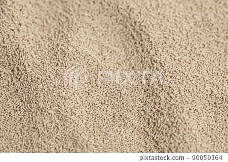 Active dry baking yeast granules background texture, top view 90059364