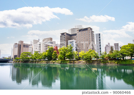 It is a building area along the river on the south side of Hiroshima Station. Business hotels and office buildings are lined up. Please use it as a background for the cityscape. 90060466