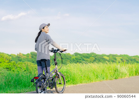Women cycling with a mini velo, small wheel bike, folding bike 90060544
