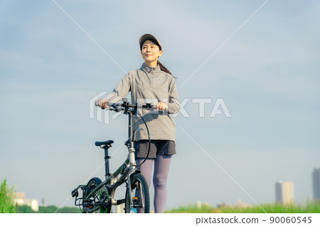 Women cycling with a mini velo, small wheel bike, folding bike Women cycling with a mini velo, small wheel bike, folding bike 90060545