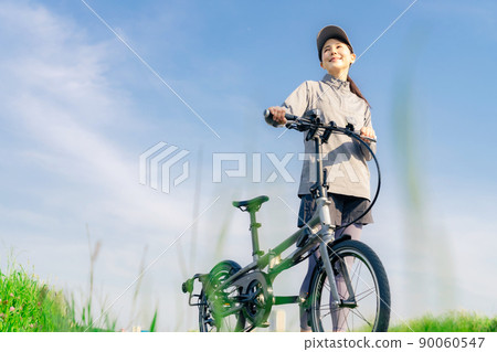 Women cycling with a mini velo, small wheel bike, folding bike Women cycling with a mini velo, small wheel bike, folding bike 90060547