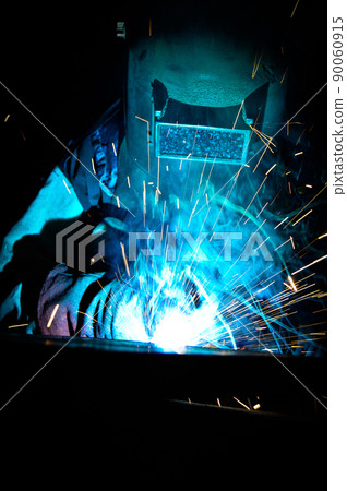 Welder uses torch to make sparks during manufacture of metal equipment Welder uses torch to make sparks during manufacture of metal equipment 90060915