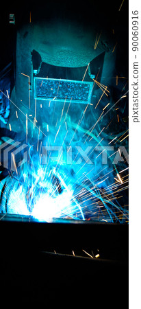 Welder uses torch to make sparks during manufacture of metal equipment Welder uses torch to make sparks during manufacture of metal equipment 90060916