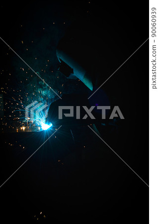Welder uses torch to make sparks during manufacture of metal equipment Welder uses torch to make sparks during manufacture of metal equipment 90060939