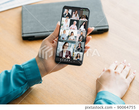 Mobile teleconference. Remote management. Telecommuting meeting. Business team brainstorming working online in virtual office on phone screen. 90064755