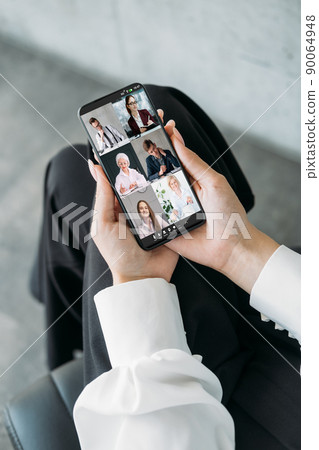 Mobile teleconference. Remote management. Telecommuting meeting. Business team brainstorming working online in virtual office on phone screen. 90064948