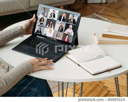 Video interview. Remote meeting. Online conference. Female executive watching business team working online discussing project on laptop screen at home office. Video interview. Remote meeting. Online conference. Female executive watching business team working online discussing project on laptop screen at home office. 90065024