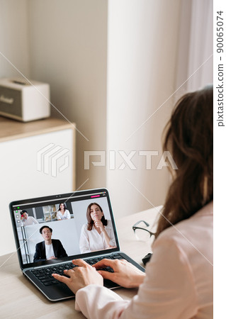 Video conference. International cooperation. Remote communication. Diverse business team working online discussing project on laptop screen. 90065074