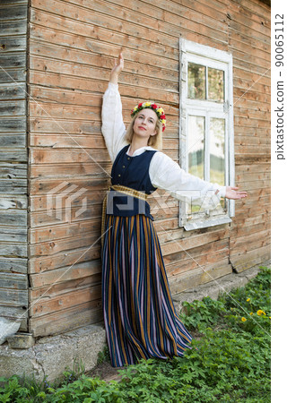 Woman in traditional clothing posing on nature in village. Woman in traditional clothing posing on nature in village. 90065112