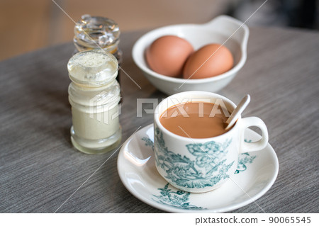 Coffee with boiled eggs, soy sauce and white pepper on table. Coffee with boiled eggs, soy sauce and white pepper on table. 90065545