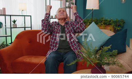 Repair work at neighbours concept, irritated old man at home cover ears with hands annoyed by noise Repair work at neighbours concept, irritated old man at home cover ears with hands annoyed by noise 90065744