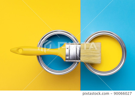Can of yellow paint on yellow and blue background. 90066027